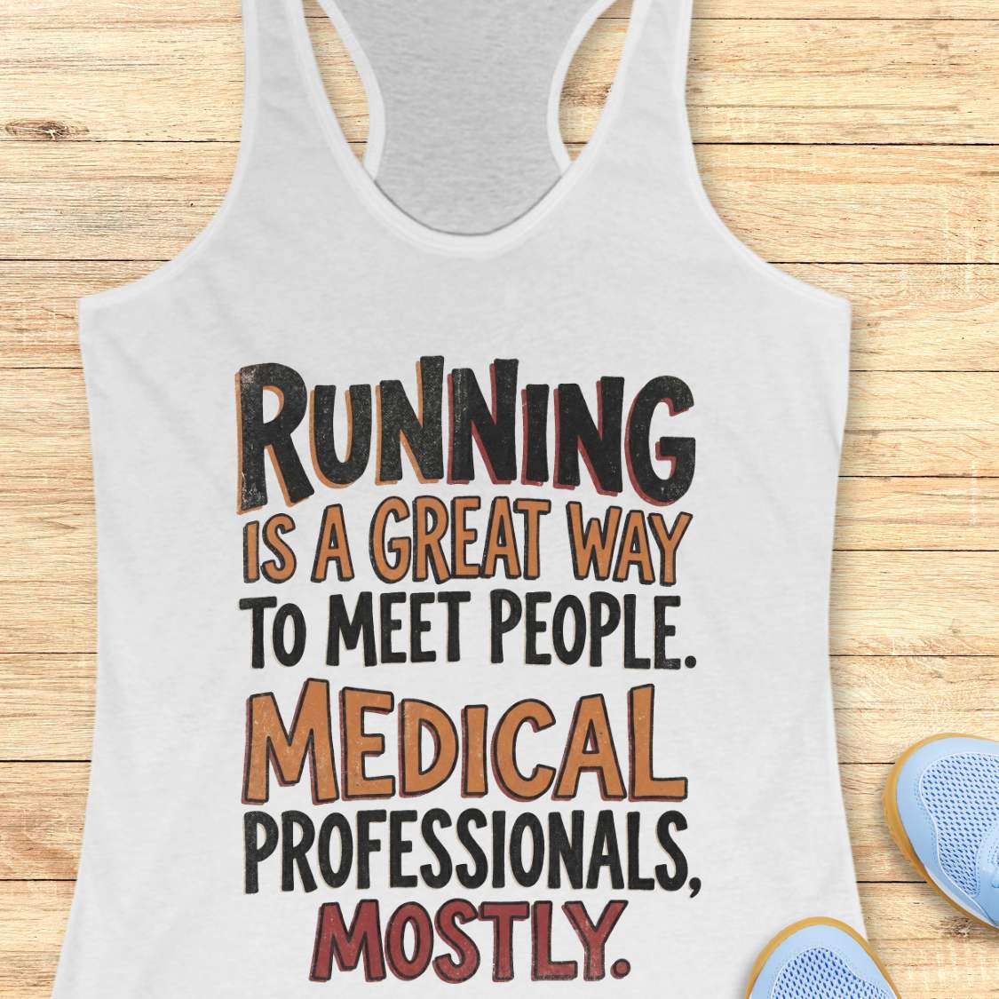 white tank top with humorous text on a wooden surface