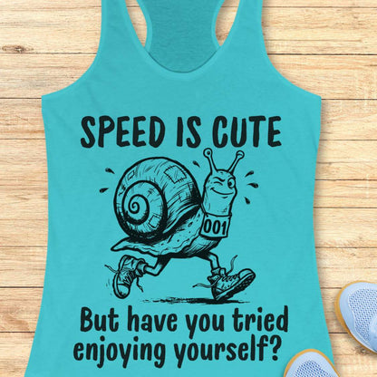 blue tank top with a snail image and text - speed is cute but have you tried enjoying yourself? on a wooden background