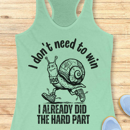 mint tank top with an image of  snail and text - I don't need to win I already did the hard part, on a wooden background