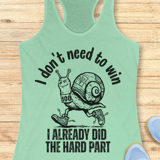 mint tank top with an image of  snail and text - I don't need to win I already did the hard part, on a wooden background