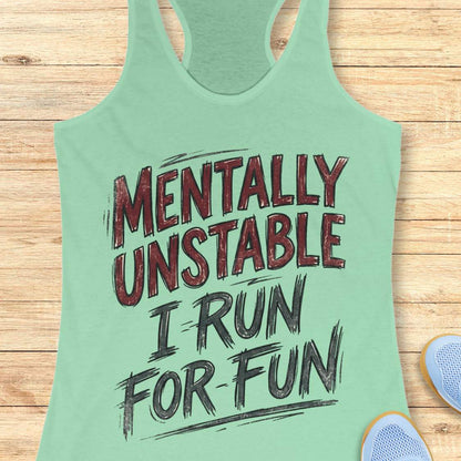 Green tank top with text 'Mentally Unstable I Run For Fun' on a wooden surface.