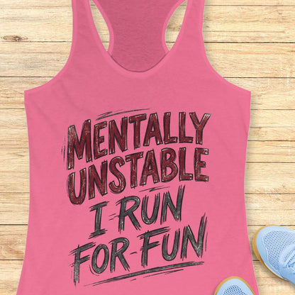 Pink tank top with text 'Mentally Unstable I Run For Fun' on a wooden surface.