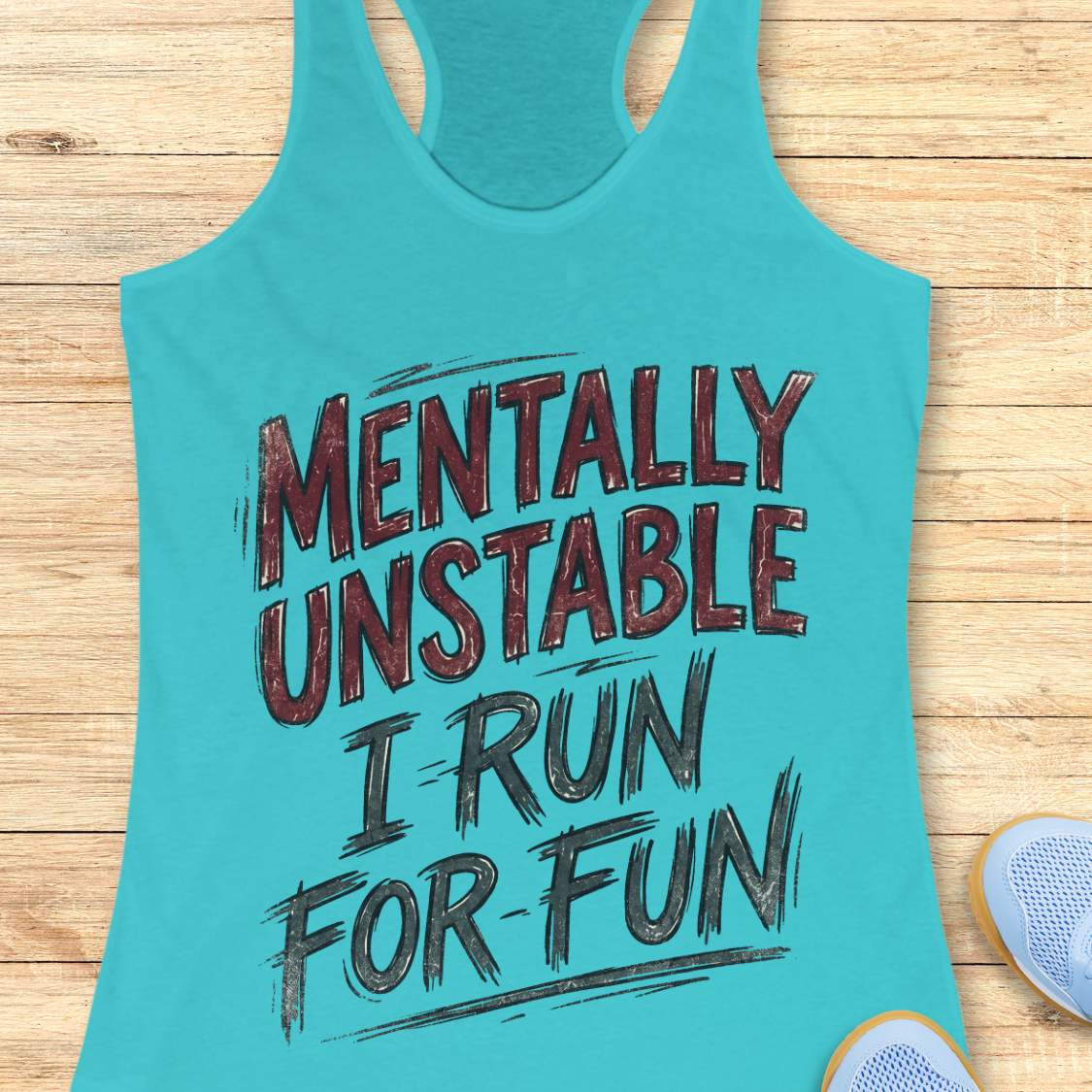 Turquoise tank top with text 'Mentally Unstable I Run For Fun' on a wooden surface.