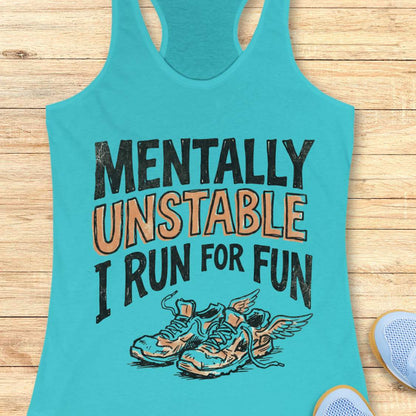 Turquoise tank top with motivational text and shoe graphic on a wooden surface