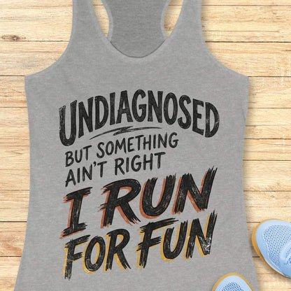 Gray tank top with humorous text undiagnosed but something ain't right, I run for fun,  design on a wooden surface
