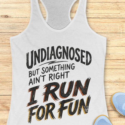 white tank top with humorous text undiagnosed but something ain't right, I run for fun, design on a wooden surface