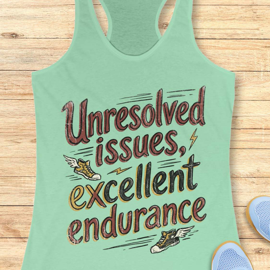 Mint green tank top with text 'Unresolved issues, excellent endurance' on a wooden surface.