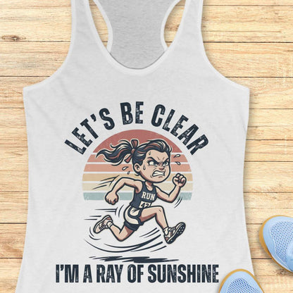 white tank top with a graphic of a running person and text let's be clear, I'm a ray of sunshine on a wooden surface