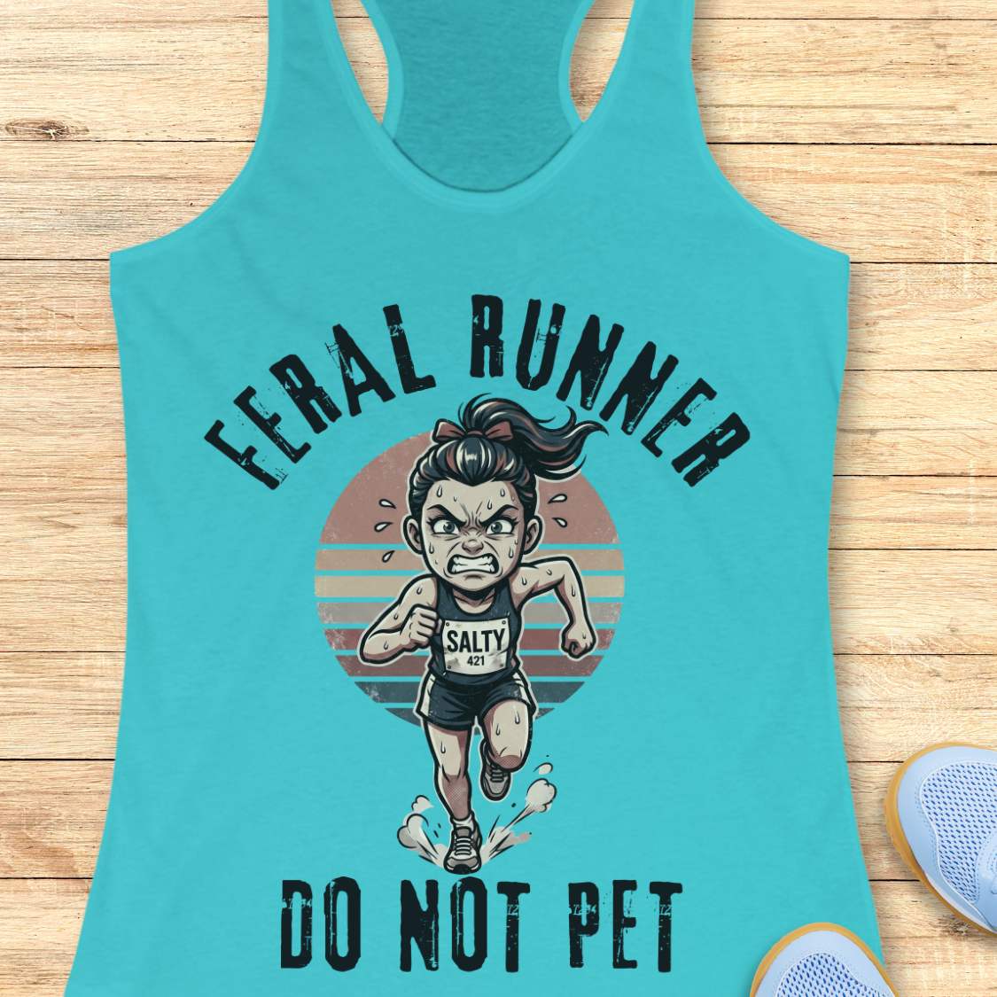 Turquoise tank top with graphic design of a running person and text feral runner do not pet on a wooden surface