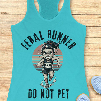 Turquoise tank top with graphic design of a running person and text feral runner do not pet on a wooden surface