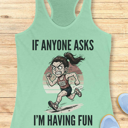 Mint green tank top with a graphic of a runner and text if anyone asks I'm having fun on a wooden surface