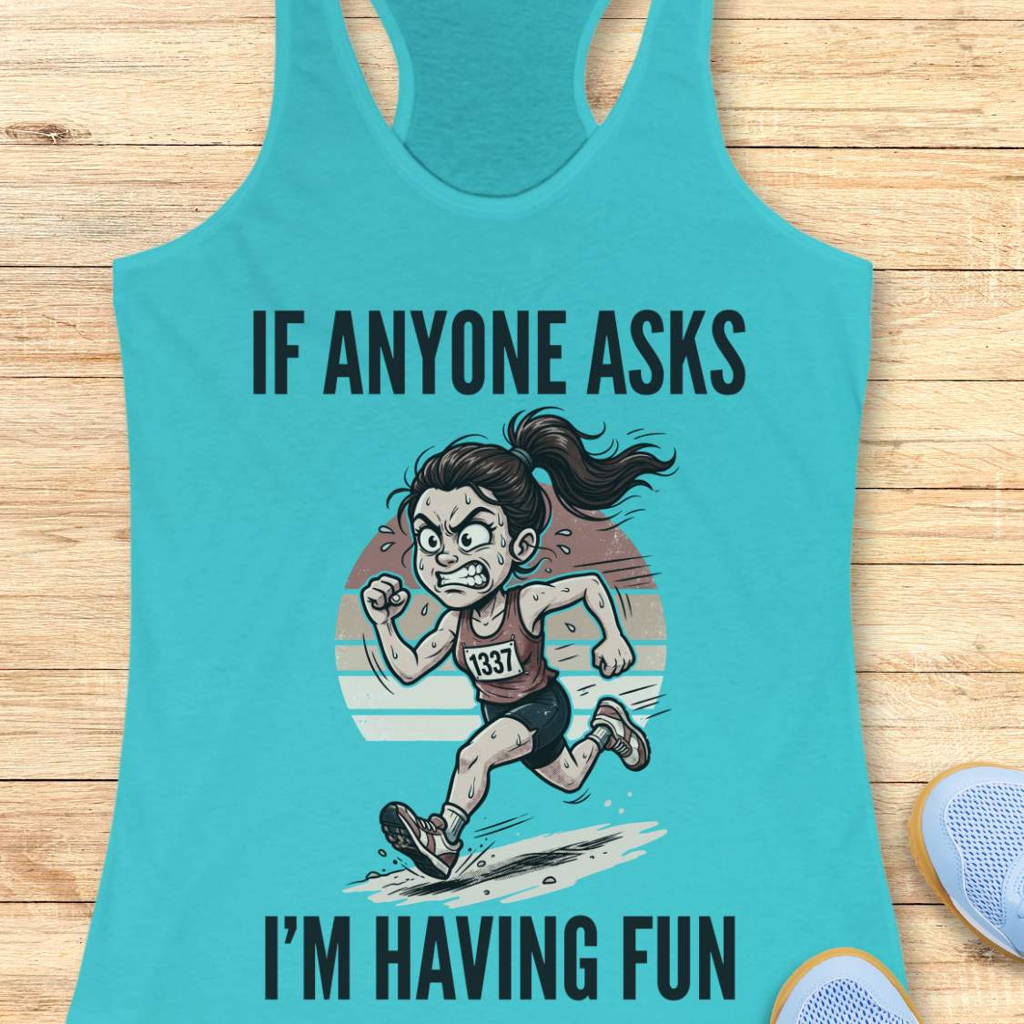 Turquoise tank top with a graphic of a runner and text if anyone asks I'm having fun  on a wooden surface
