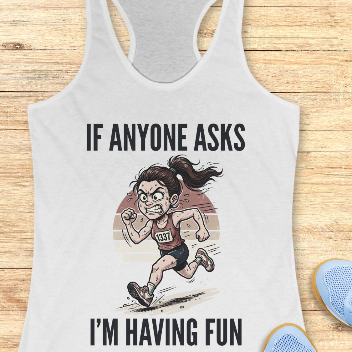 White tank top with a graphic of a runner and text 'If anyone asks, I'm having fun' on a wooden surface.