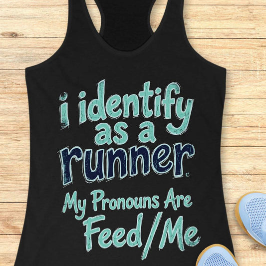 Black tank top with text 'i identify as a runner My Pronouns Are Feed/Me' on a wooden surface.