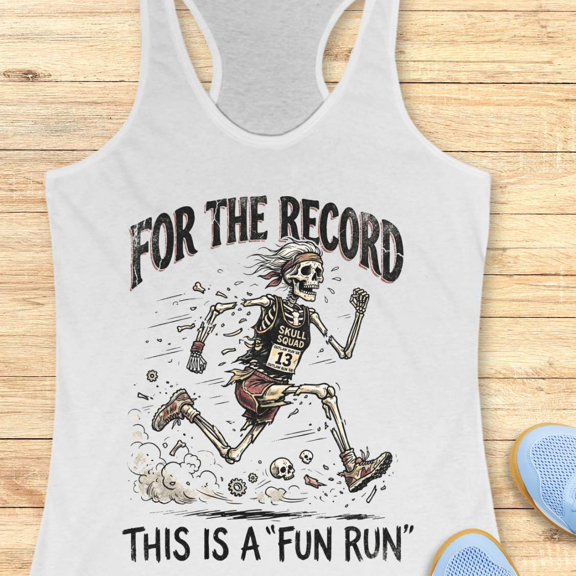 white tank top with skeleton graphic and text 'For the Record, This is a Fun Run' on a wooden surface.