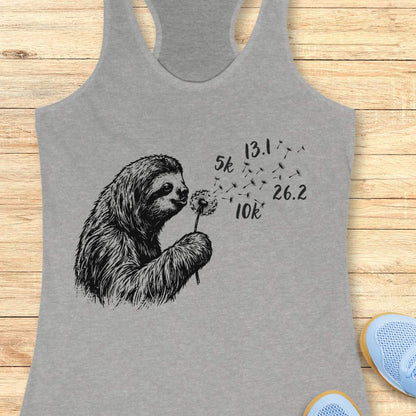 Gray tank top with a sloth holding a dandelion on a wooden surface