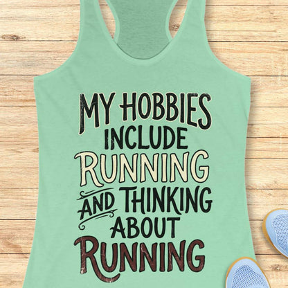 Mint green  tank top with text 'My hobbies include running and thinking about running' on a wooden surface.