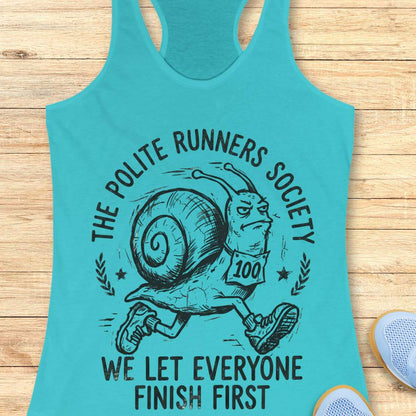 Turquoise tank top with a graphic of a snail and text 'The Polite Runners Society' on a wooden surface