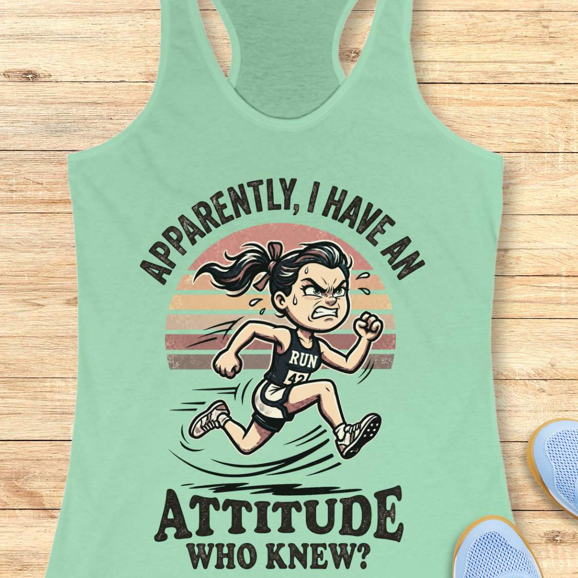 Mint green tank top with a graphic of a running woman and text on a wooden surface