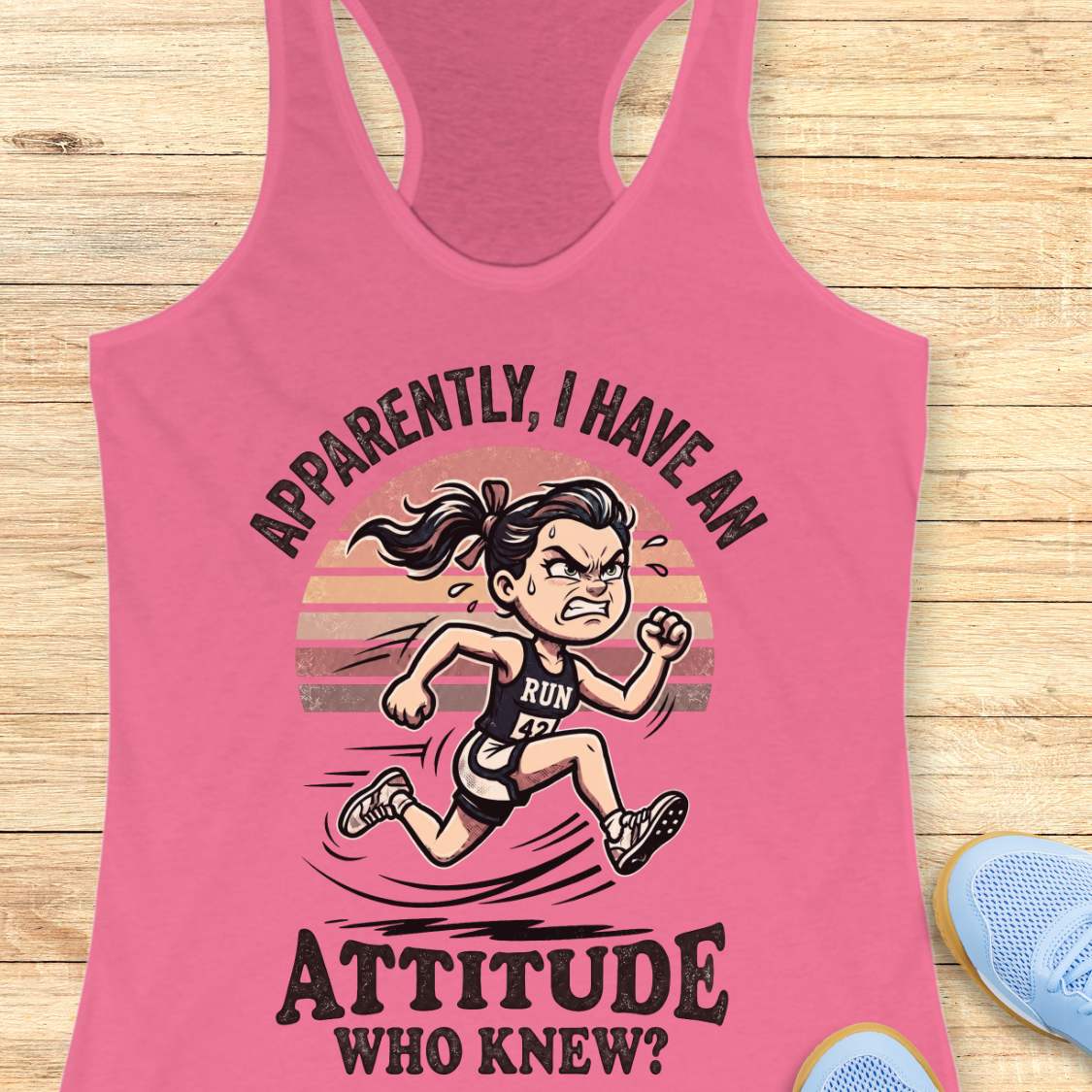 Pink tank top with a graphic of a running person and text on a wooden surface