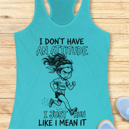Turquoise tank top with a graphic of a running girl and text I don't have an attitude, I just run like I mean it, on a wooden surface