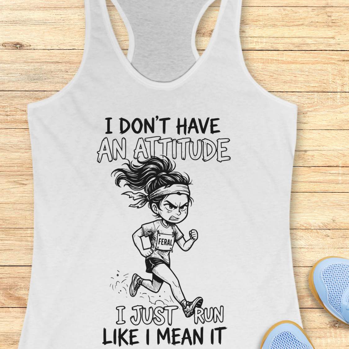 Gray tank top with a graphic and text I don't have an attitude, I just run like I mean it, on a wooden surface