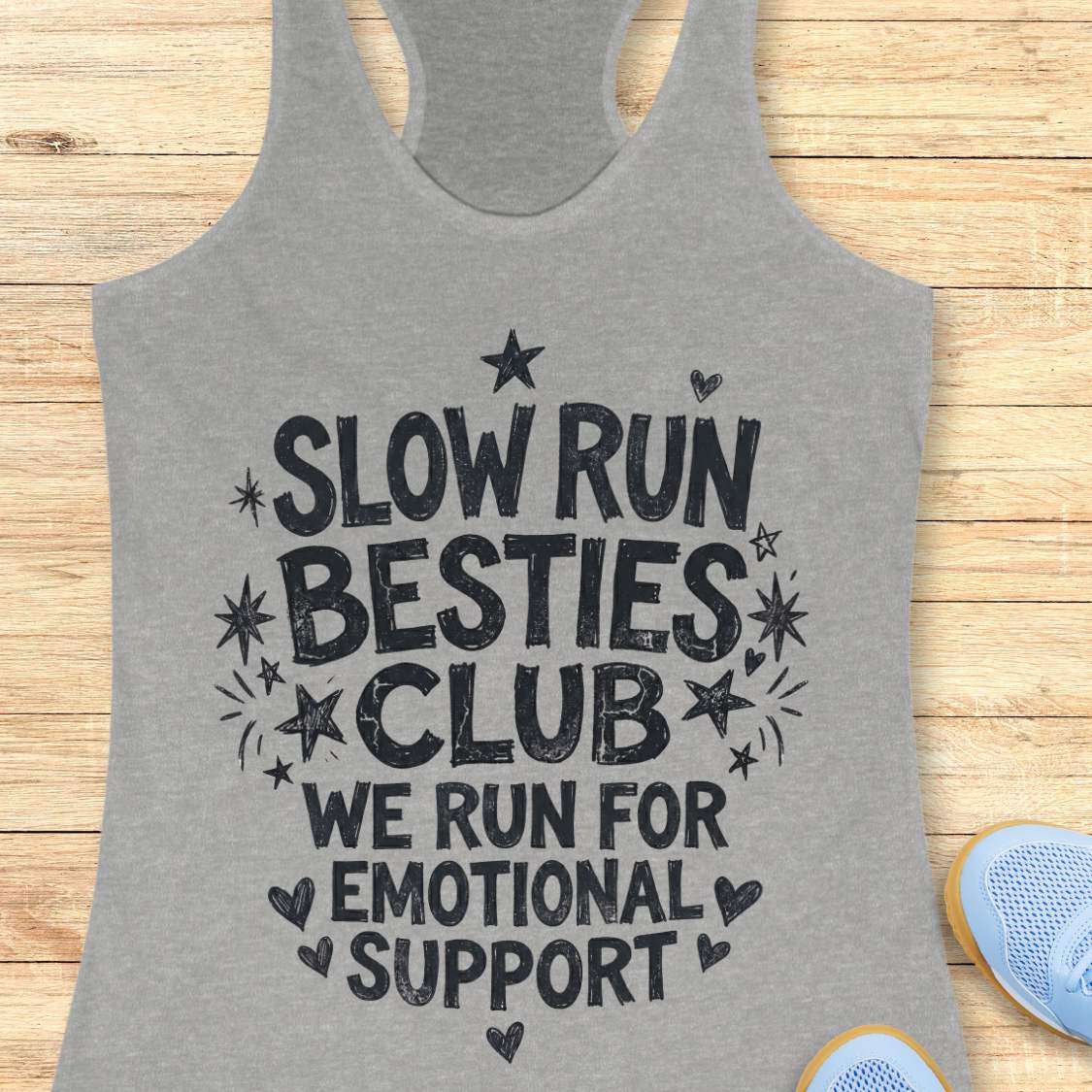 Gray tank top with 'Slow Run Besties Club' text on a wooden surface