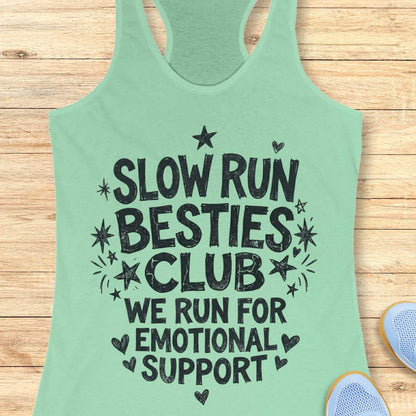 Green tank top with 'Slow Run Besties Club' text on a wooden surface