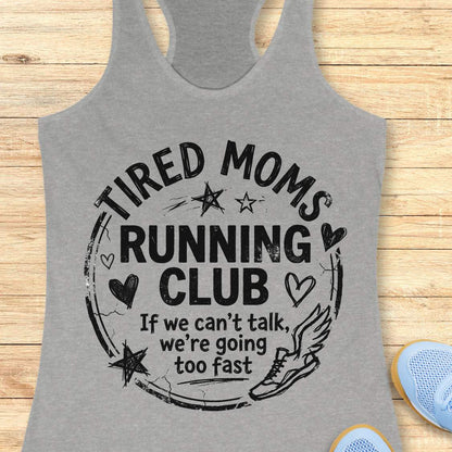 Gray tank top with 'Tired Moms Running Club' text on a wooden surface