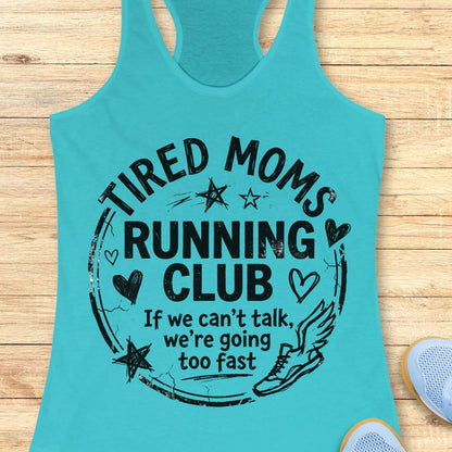 Turquoise tank top with 'Tired Moms Running Club' text on a wooden surface