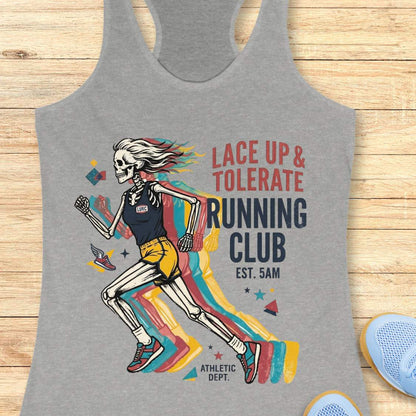 Gray tank top with skeleton design and 'Lace Up & Tolerate Running Club' text on a wooden surface