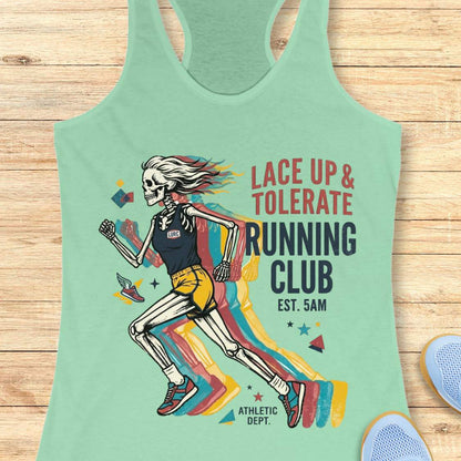 Light green tank top with skeleton design and text  Lace up & tolerate running club, on a wooden surface