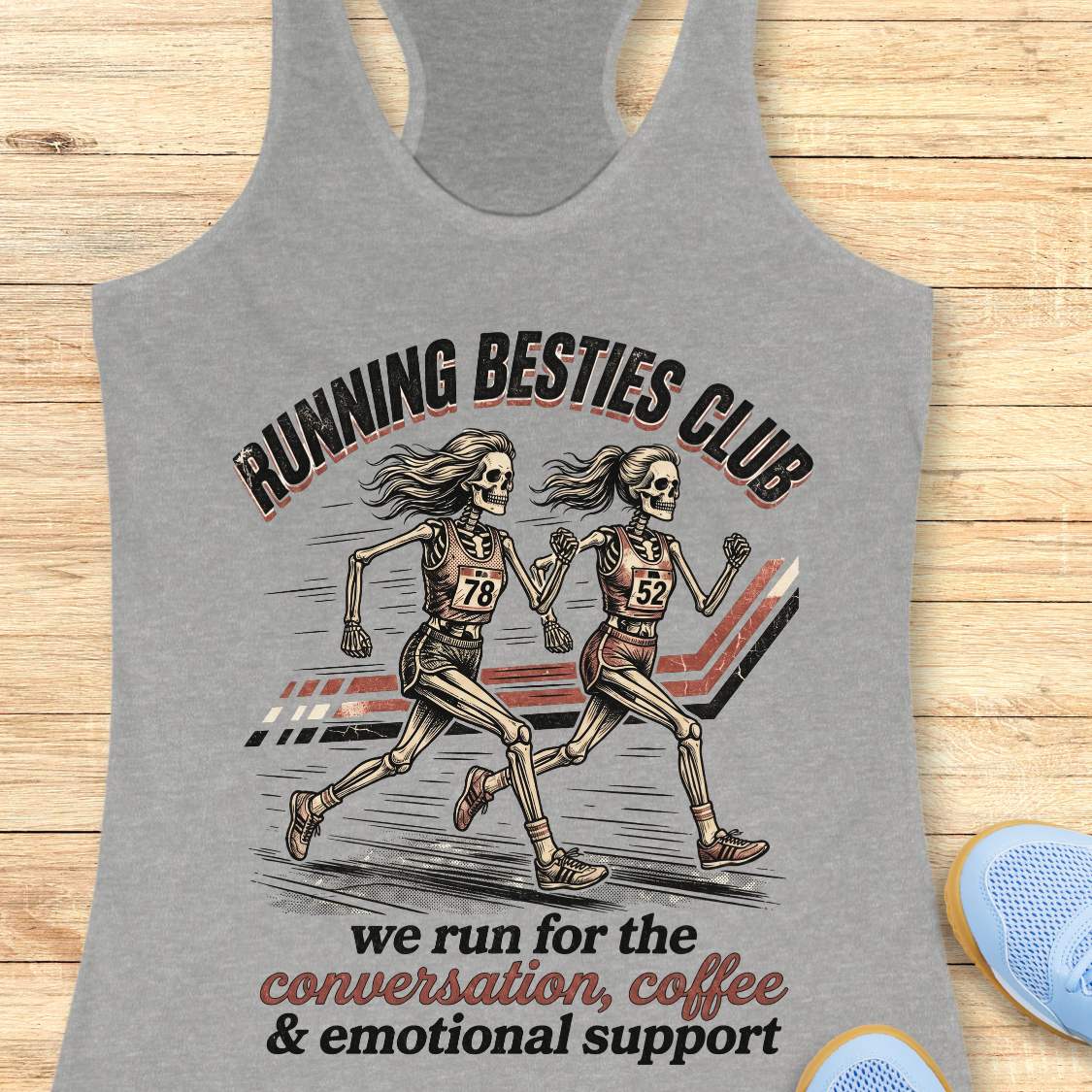 Gray tank top with skeleton runners and 'Running Besties Club' text on a wooden surface