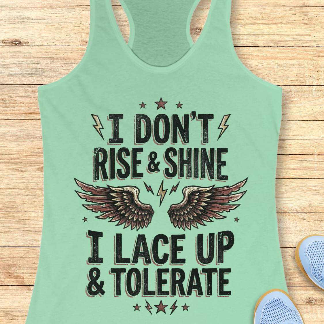 Mint green tank top with motivational quote I don't rise & shine, I lace up & tolerate,  on a wooden surface