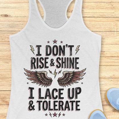 white tank top with motivational text I don't rise & shine, I lace up & tolerate, and wings on a wooden surface