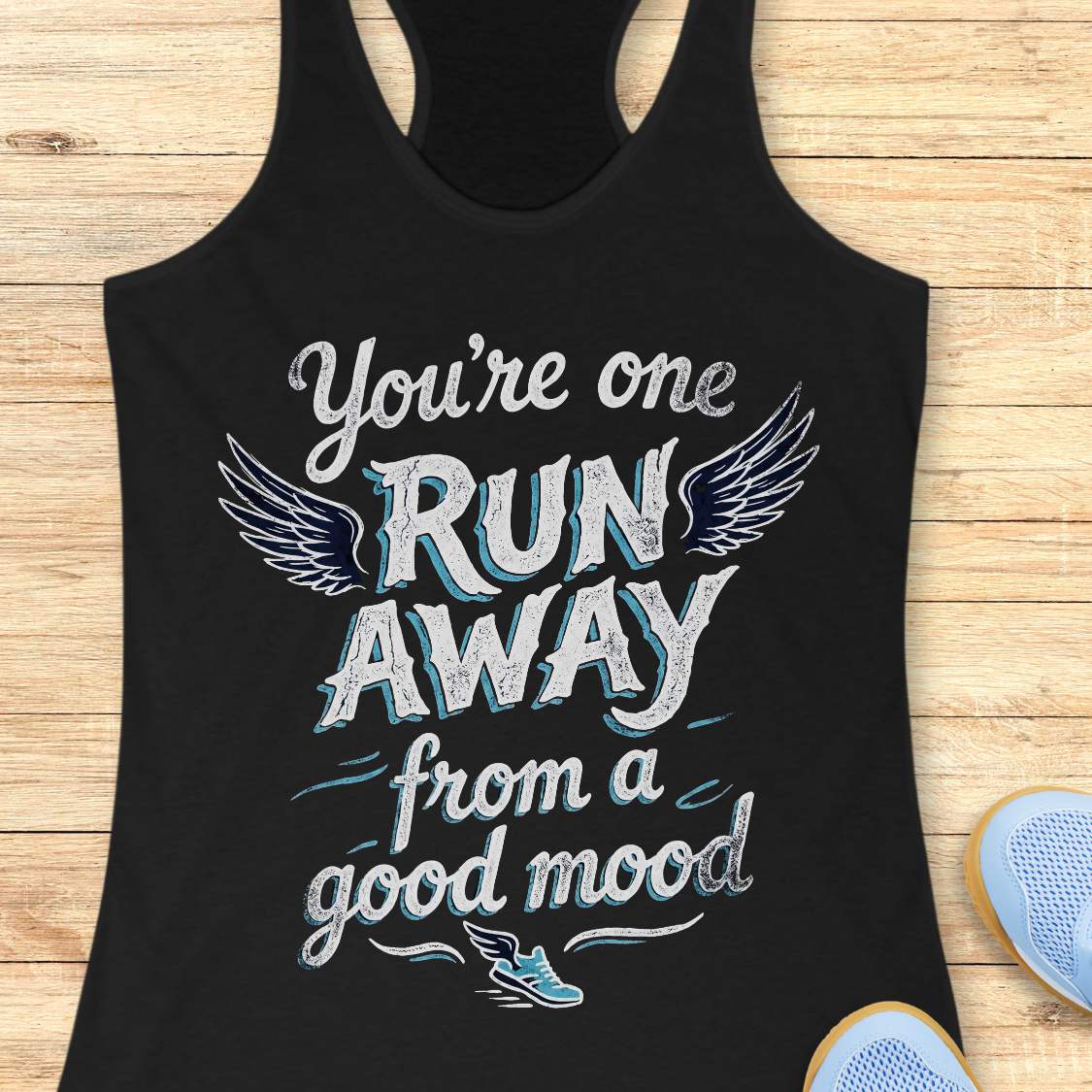Black tank top with text 'You're one run away from a good mood' on a wooden surface.