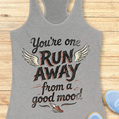 Gray tank top with text 'You're one run away from a good mood' on a wooden surface.