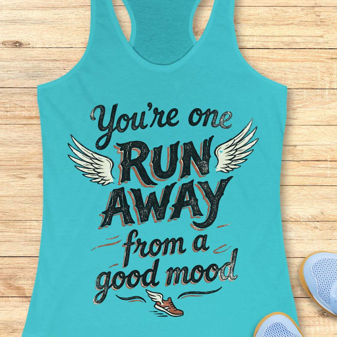 Turquoise tank top with text 'You're one run away from a good mood' on a wooden surface.