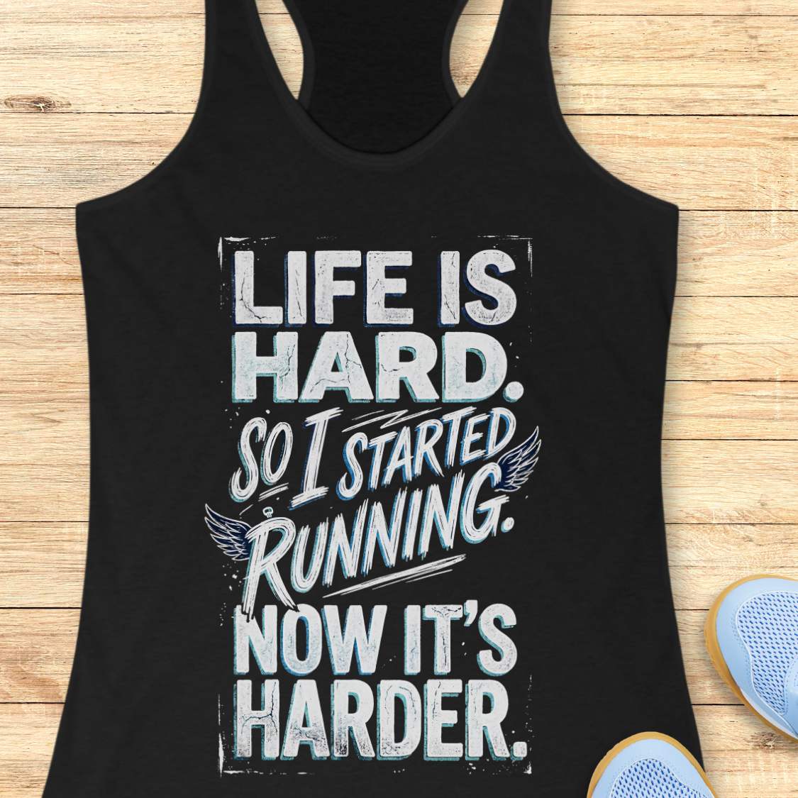 Black tank top with with funny quote life is hard. So I started running. Now it's harder. on a wooden surface