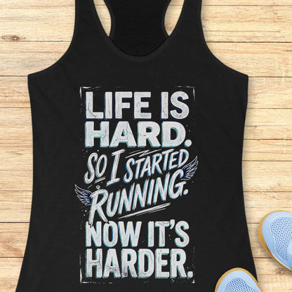 Black tank top with with funny quote life is hard. So I started running. Now it's harder. on a wooden surface