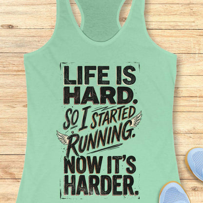 Mint green tank top with with funny quote life is hard. So I started running. Now it's harder. on a wooden surface