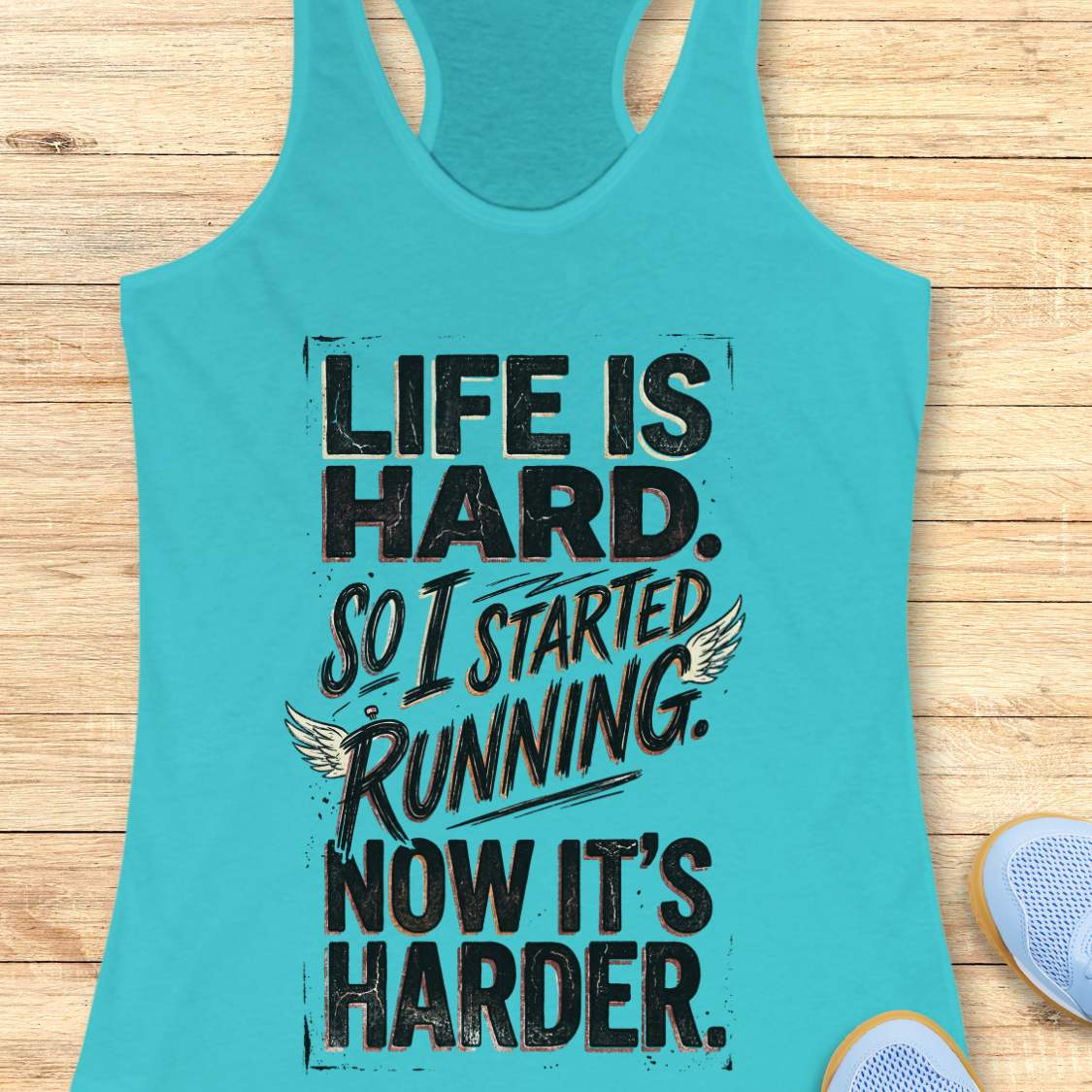 Turquoise tank top with funny quote life is hard. So I started running. Now it's harder. on a wooden surface