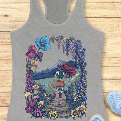 Gray tank top with a colorful graphic of a person with red hair walking through flowers on a wooden surface.