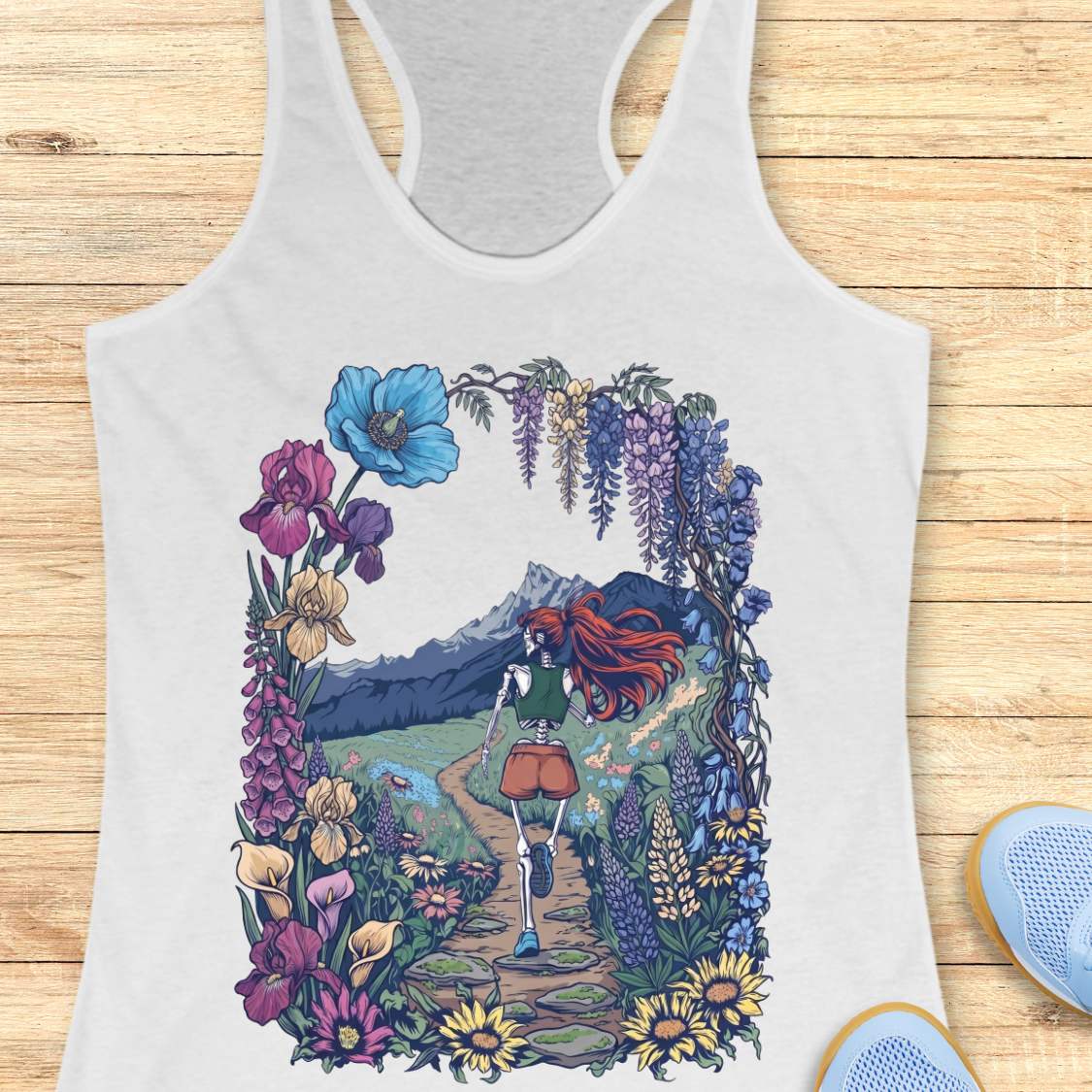 white Tank top with a colorful graphic of a person with red hair walking through flowers on a wooden surface.