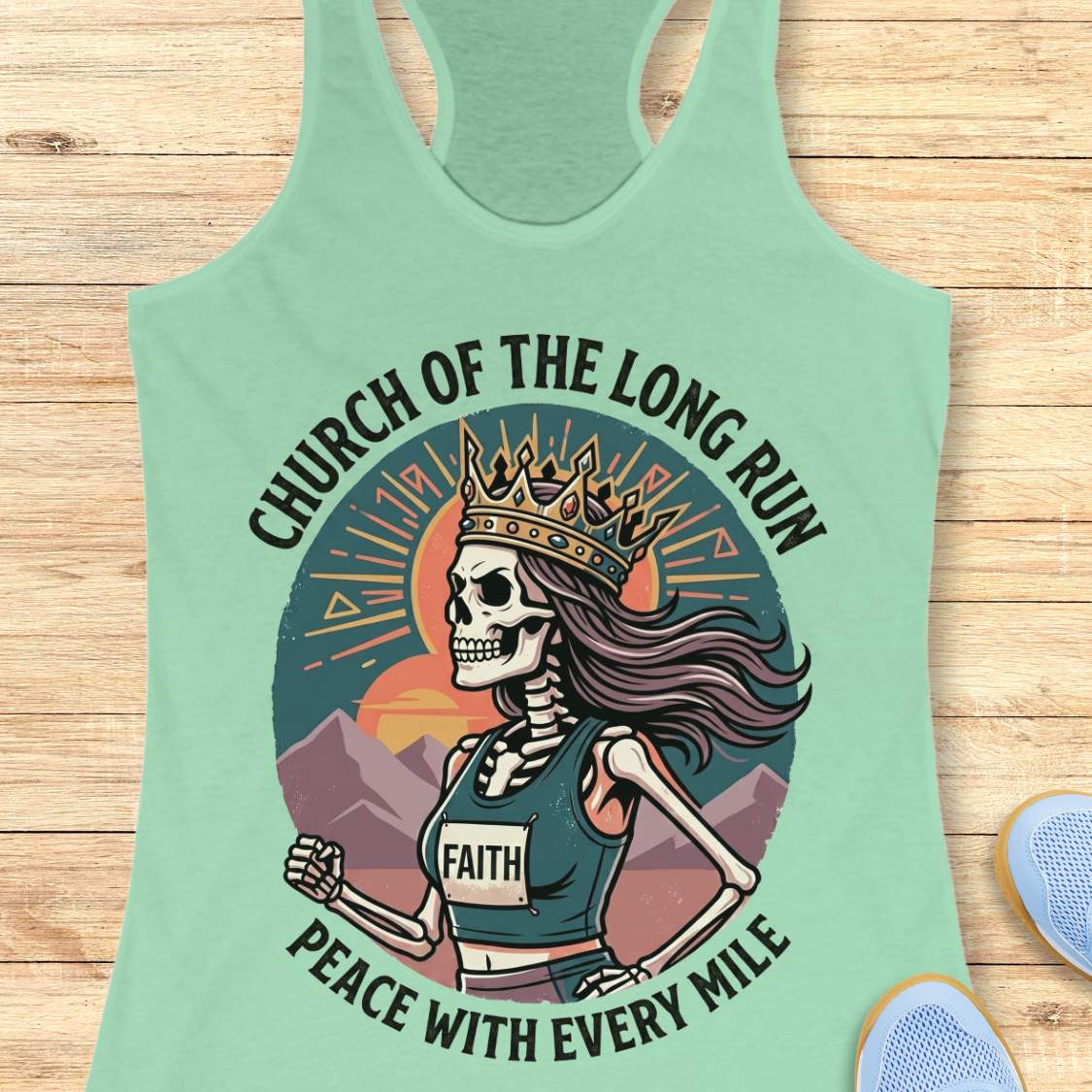 Mint green tank top with skeleton graphic and text Church of the long run, peace with every mile, on a wooden surface