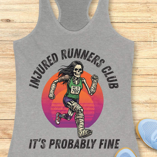 Gray tank top with skeleton runner graphic and 'Injured Runners Club' text on a wooden surface