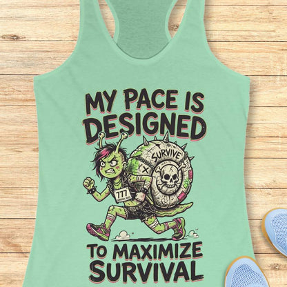 Mint green tank top with graphic design and text my pace is designed to maximize survival, on a wooden surface