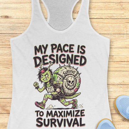 white tank top with graphic design and text my pace is designed to maximize survival,  on a wooden surface