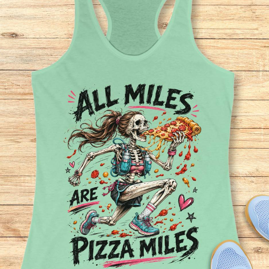 Mint green tank top with skeleton running and pizza design and text 'All Miles are Pizza Miles' on a wooden surface
