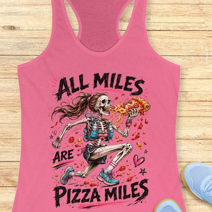 Pink tank top with skeleton holding a pizza and 'All Miles are Pizza Miles' text on a wooden surface.